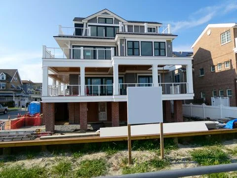 A modern new home that is elevated is seen being constructed Stock Photos