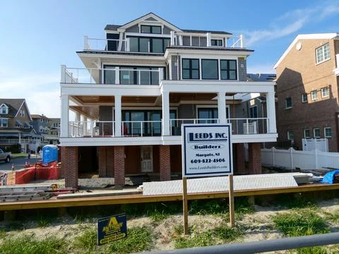 A modern new home that is elevated is seen being constructed Stock Photos