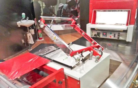 A modern noodle museum workshop machine sits behind glass Stock Photos