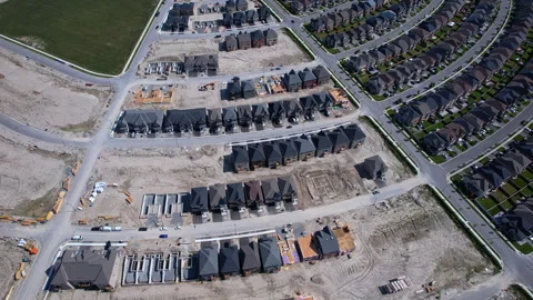 Modern North American homes in construction near live in community. Aerial .. Stock Footage 346728701