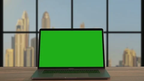 Modern notebook with open green mock-up template monitor on office desk close-up Stock Footage 117429595
