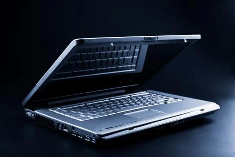 Modern notebook over black background Stock Photos