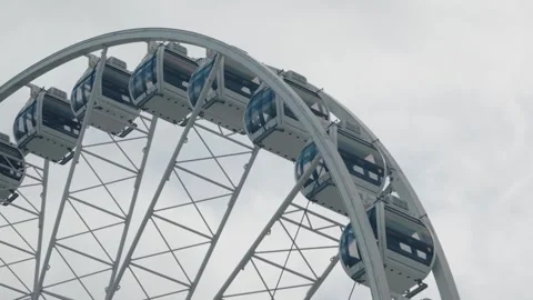 Modern Observation Wheel Gondolas Under an Overcast Sky Stock Footage 343673153