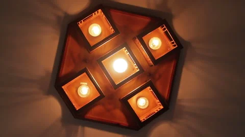 Modern octagonal wooden ceiling lamp with five bulbs turning on and off Stock Footage 327158505