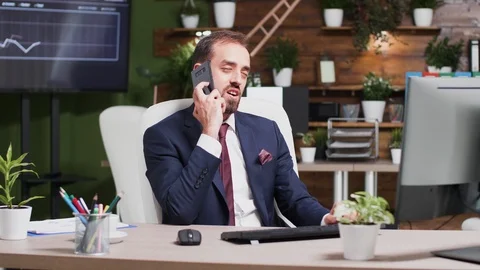 In modern office, after work hours, a businessman is talking on the phone Stock Footage 109605165