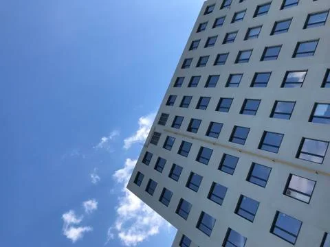 Modern office building on a background of clouds Stock Photos