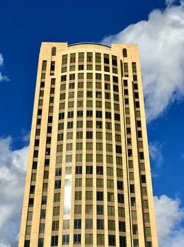 Modern office building in the background of sky and clouds Stock Photos