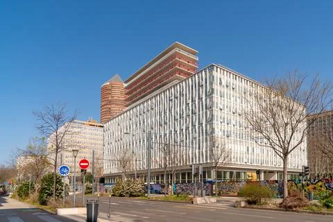 Modern office building with distinctive facade and construction on upper fl.. Stock Photos
