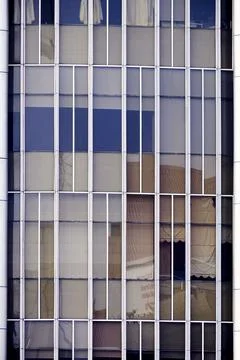 Modern office building facade close-up with minimalist vertical frames Stock Photos