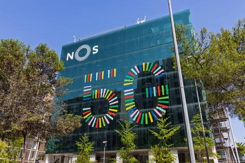 A modern office building facade features a colorful '5G' graphic and the 'NOS Stock Photos