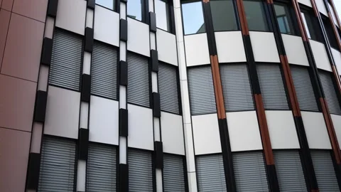 Modern office building facade with geometric pattern, closed window blinds, and  Stock Footage 304885478