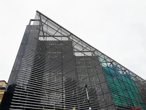 Modern office building facade with horizontal metal louvers and glass curta.. Stock Photos