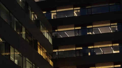 Modern office building facade at night with lights inside rooms 動画素材 344010787