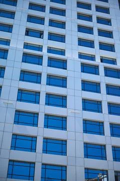 Modern office building facade with reflective blue windows in Casablanca ci.. Stock Photos