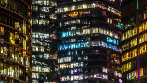 Modern office building with large windows at night, light shines in the windo Stock Footage 146153557