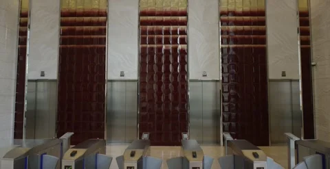 Modern office building lobby with elevators and security turnstiles. Stockbeeldmateriaal 330155182