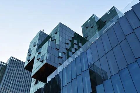 Modern office building with reflection in windows of skyscraper. Business backgr Stock Photos