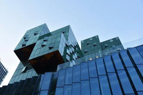Modern office building with reflection in the windows. Architectural detail. Stock Photos