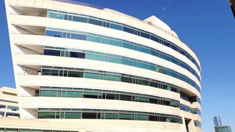 Modern office building with reflective windows under a clear blue sky. Stock Footage 312517807