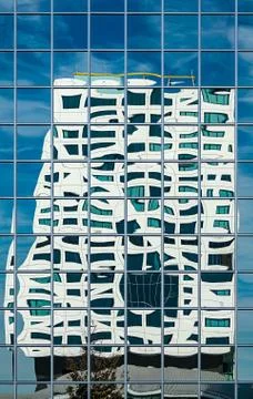 Modern office builing reflected in a glass facade Stock Illustration