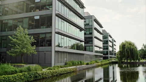Modern office complex with glass fronted buildings in a scenic landscaped garden Video stock 88040242