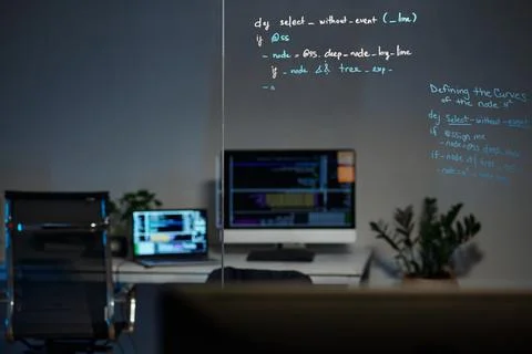 Modern Office with Computer and Code on Glass Board Stock-Fotos