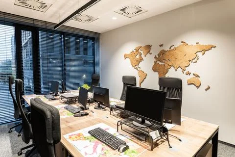 Modern office with computer stations. Large windows overlooking the city. W.. Stock Photos