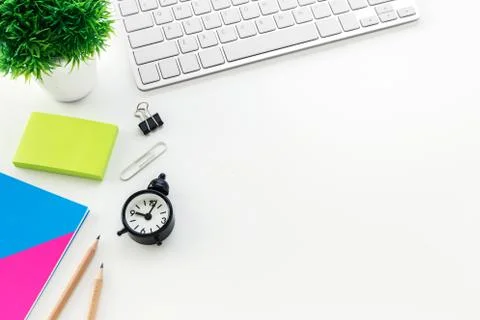 Modern office desk with computer blank notepad pencil clock with copy space Stock Photos