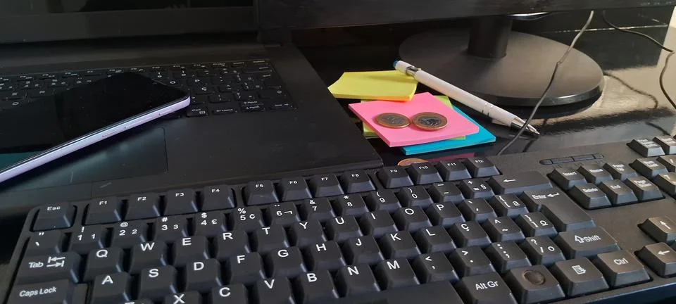 Modern office desk with computer keyboard. Professional workspace with sticky Stock Photos
