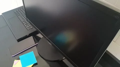 Modern office desk setup featuring black computer monitor motion video clip Stock Footage 340038110