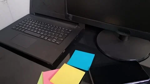 Modern office desk setup with laptop and sticky notes motion video Stock Footage 340038061