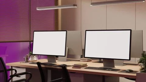 Modern office with desktop computer mockups and ambient evening lighting Stock Illustration