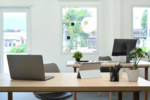 Modern office interior with laptop computer, documents and various office Stock Photos