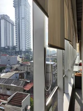 Modern Office Interior with Large Windows Overlooking Cityscape Stock Photos