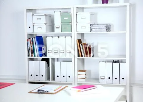 Modern office interior with tables, chairs and bookcases Stock-Fotos