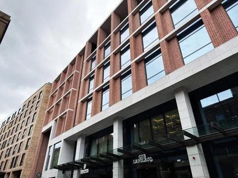 Modern office One Le Pole Square building facade with glass windows brick d.. Stock Photos