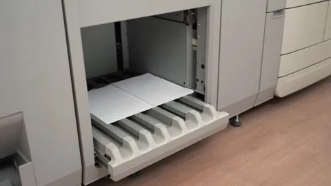 This is a modern office printer equipped with a paper tray for added convenience Stock-Footage 300490073