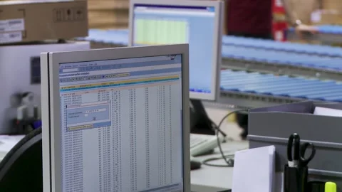 Modern Office Setup with Computers and Spreadsheets Displayed Stock Footage 316740844