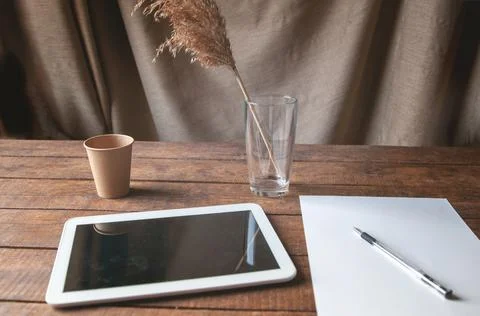 Modern office workplace with tablet pc on the table. On the table is a tablet Stock Photos