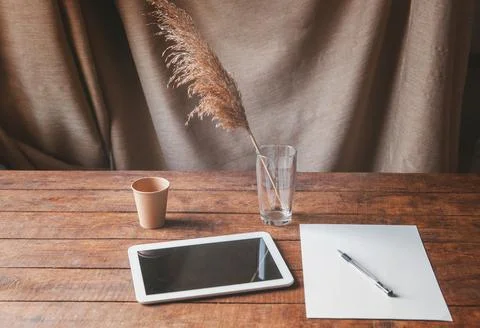 Modern office workplace with tablet pc on the table. On the table is a tablet Stock Photos