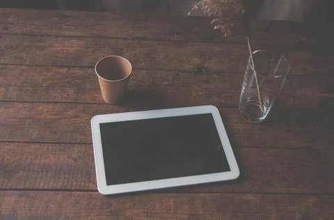Modern office workplace with tablet pc on the table. On the table is a tablet Stock Photos