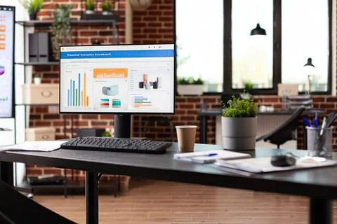 Modern office workspace with computer and charts Stock Photos
