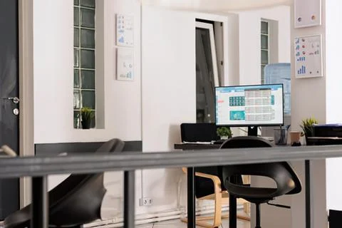 Modern office workspace with computer and chair Stock Photos