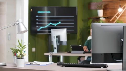 Modern office workspace with computer and charts Stock Photos