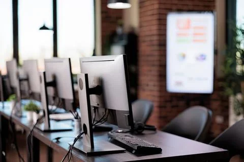 Modern office workspace with computer monitors and desk setup Stock Photos
