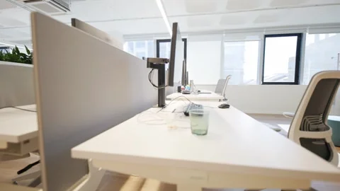 Modern office workspace featuring multiple desks with computers, ergonomic Stock Footage 335945863