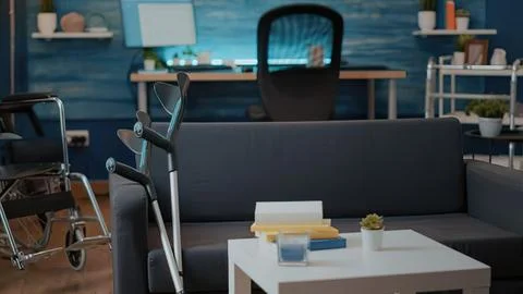 Modern office workspace with gray sofa and desk Stock Photos