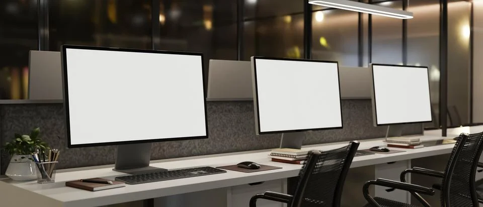 Modern office workspace with multiple desktop computer mockups. Illustrazione stock