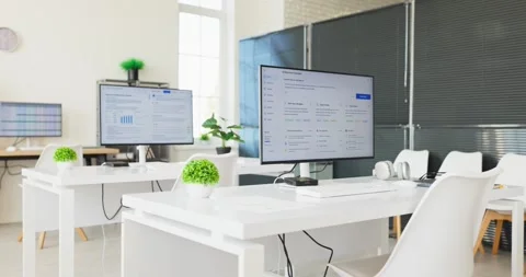 Modern office workstations with monitors displaying spreadsheet data and Video stock 348155833