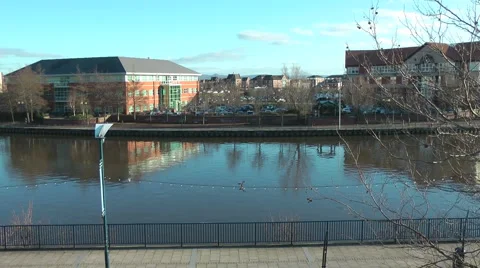 Modern Offices on opposite bank, reflected in urban river Stock Footage 1060053